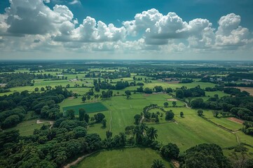 Obraz premium Scenic rural area with lush greenery and cloudy sky seen from above