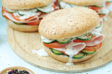 Bun sandwiches with salami and vegetables	