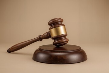 Isolated judge's hammer on plain backdrop