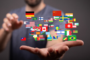 Image of hands holding a network of interconnected flags representing global connections and international relations.