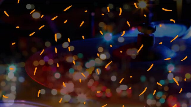 Animation of confetti falling over percussion an blurred night cityscape