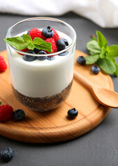 chia pudding with natural yogurt and fresh berries close-up on the table.. Vertical photo format