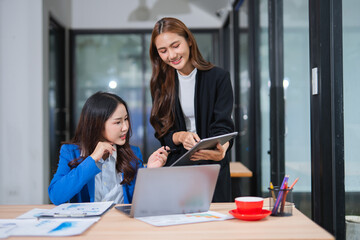 Obraz premium Accountants or business people working together on a project. Two female business colleagues are working on computers.