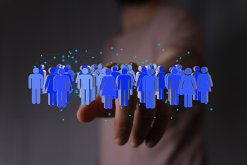 Image depicts a hand interacting with a digital network of people, symbolizing global connection...