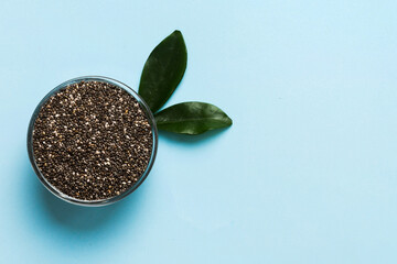 Chia seeds in bowl on colored background. Healthy Salvia hispanica in small bowl. Healthy superfood