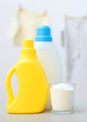 Baby clothes and detergents on the table. Baby clothes care concept.. Vertical photo format
