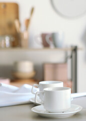 Pure water boils in an electric kettle on the table in the kitchen. Vertical photo format