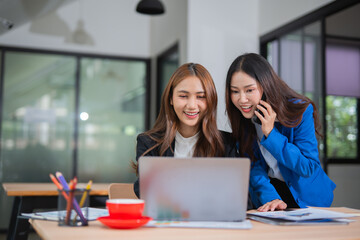 Accountants or business people working together on a project. Two female business colleagues are working on computers.