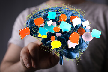 Abstract image of a brain with colorful speech bubbles, symbolizing communication, ideas, and...