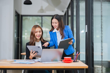 Accountants or business people working together on a project. Two female business colleagues are working on computers.