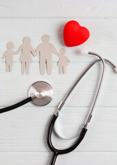 stethoscope and heart on a colored background top view. Family medicine. Vertical photo format