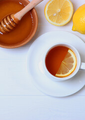 tea, honey and lemon on the table top view.. Vertical photo format
