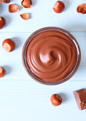 chocolate paste in a glass jar on a colored background. . Vertical photo format