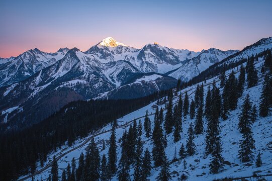 Tranquil snow-covered mountain range at dawn near a high mountain pass in the northern region