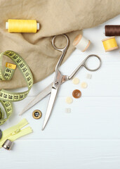 different sewing accessories on the table close-up. Vertical photo format