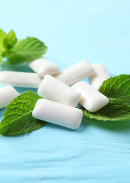 mint chewing gum and mint on the table. Fresh breath, oral care. Vertical photo format