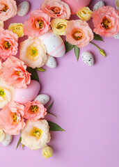 Flowers and Easter eggs on a colored background close-up. Easter background. Vertical photo format
