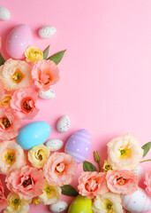 Flowers and Easter eggs on a colored background close-up. Easter background. Vertical photo format
