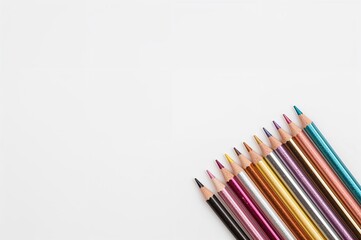 Fototapeta premium Colored pencils with metallic shine positioned on a white surface in the upper left corner. Aerial perspective with room for writing. Detailed capture, educational motif for children's artwork.