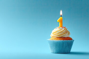 Single cupcake with a lit yellow number one candle on a light teal background