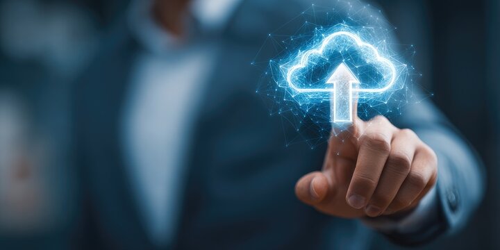 A hand touches a glowing upload cloud graphic