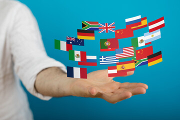 Image of diverse flags hovering above a hand, symbolizing international business, global...