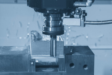 The CNC milling machine finish cut the aluminum housing parts with flat nose end mill tool in the...