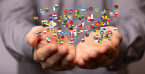 Image of hands gently cupping numerous flags, symbolizing global unity and international...