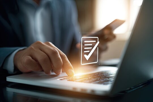 Businessperson working on laptop, smartphone in hand, with a digital checkmark overlay