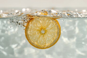 Close-up of a juicy lemon wedge submerged in water