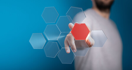 Abstract technology concept.  Man interacts with a digital hexagon network interface.