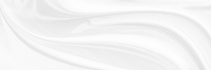 White gray satin texture that is white silver fabric silk panorama background with beautiful soft...