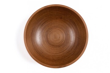 Round wooden bowl in brown color on a white backdrop, top view.