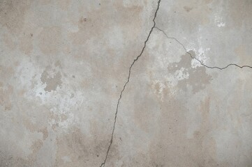 Obraz premium Background featuring a rough, fractured concrete wall texture