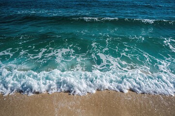 Surging ocean waves hitting a sandy shore