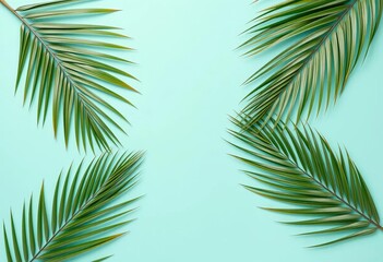 Fototapeta premium Tropical palm leaves arranged minimally on a pastel turquoise background Copy space available, flatlay, branding