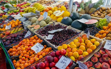 Fresh fruit at the morning street market in Italy. Cherries, melon, bananas - vitamins are cheap. Rome.