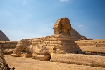 Great Sphinx of Giza with the pyramids under a clear blue sky