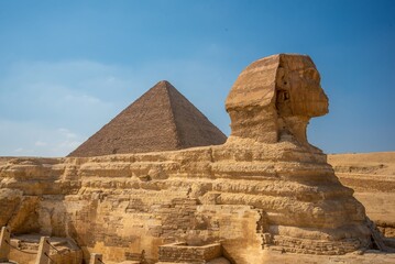 Great Sphinx of Giza with the pyramids under a clear blue sky
