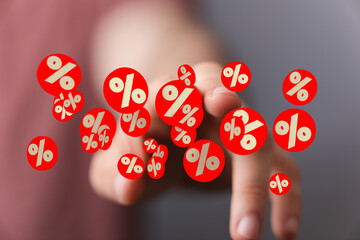 Image of a hand interacting with digital percentage symbols, ideal for discount, sale, finance...
