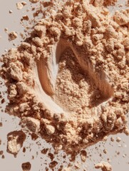 Beige Powder Close-Up Shot with a Fingerprint Impression and Flying Particles in Studio Lighting for Beauty and Cosmetics