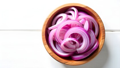 Overhead shot of thinly sliced red onions arranged in a rustic wooden bowl, set against a stark white background. The lighting is bright and even, highlighting the vibrant purple hues of the onions