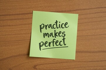 Consistent effort leads to mastery - an inspiring message on a green sticky note over textured wood