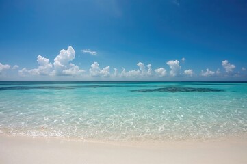 Obraz premium Scenic view of a pristine white sandy shore with crystal-clear turquoise waters. Vacation summer seaside scene. Gentle ocean waves meeting the sandy coast.