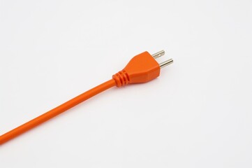 Isolated orange power cable on plain backdrop
