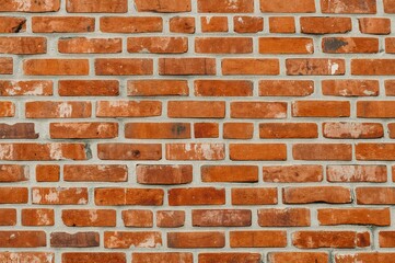 Fototapeta premium Brick wall painted orange with empty space for text