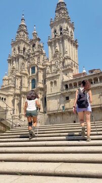 Two Friends Emotionally Embrace After Completing the 100km Camino de Santiago at Santiago Cathedral. Overcoming Physical and Mental Limits