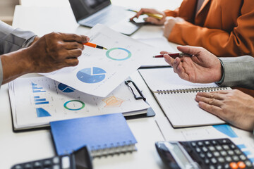 Business people analyzing monthly budget and financial report using data and chart to strategize and plan for their future business while working together in the office.
