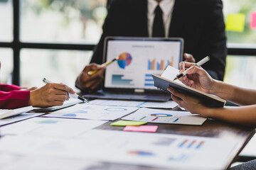 Business consultant meeting is discussing financial chart analysis, marketing growth graph and business planning. Statistical and financial analysis. Discuss the market situation and plan investments.