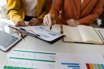 Businesswoman meeting with business consultant discussing business plan in office. Business report analysis and financial planning.